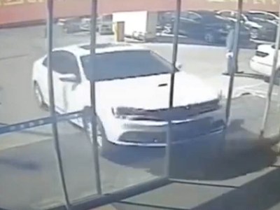 China man drives into car dealership showroom