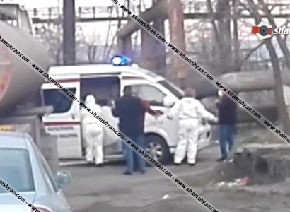 Yerevan ambulance staff puts mask on Iranian truck driver