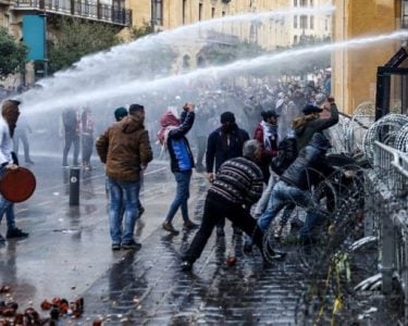 Lebanese servicemen throw tear gas grenades at demonstrators