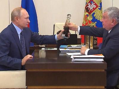 Rosneft CEO presents bottle of premium oil to Russia's Putin as a gift