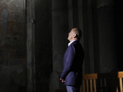 Members of "Armenia" bloc light candles at Haghpat Monastery after campaigning