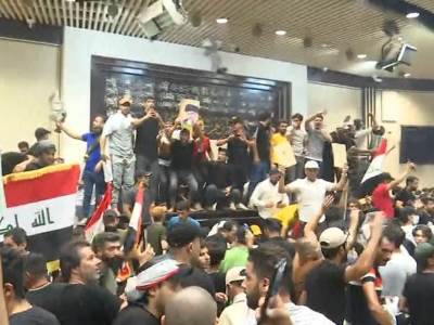 Hundreds of protesters burst into green zone in central Baghdad and storm parliament building
