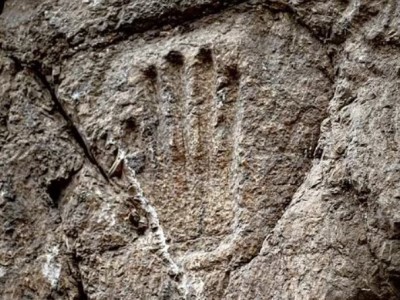 Israeli archaeologists try to uncover significance of handprint on stone wall of ancient moat