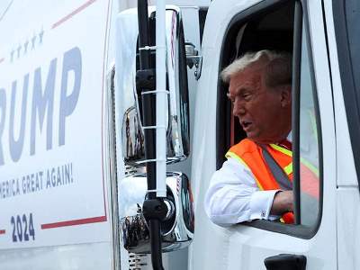 Trump gets into garbage truck after Biden's remarks about his supporters