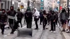 Italian priest gives middle finger to rioters in Milan (VIDEO)