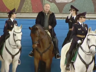 Putin rides horse alongside mounted female police officers