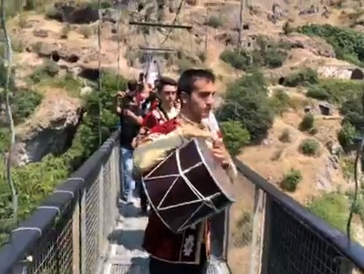 Armenia government members dance on swinging bridge of Khndzoresk