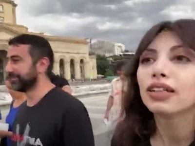 Members of Armenian opposition Adekvad Union post posters reading "Antinikol" near government building