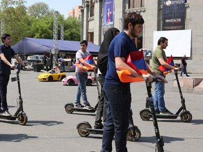 Opposition members carry out awareness campaign in Yerevan, with electric scooters