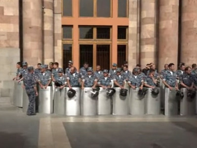 Police line up on Republic Square in anticipation of protesters approaching column