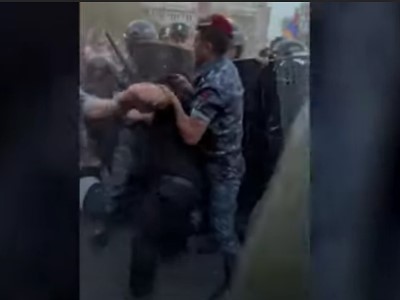 Police officer severely beats demonstrator and leaves him lying helpless on ground
