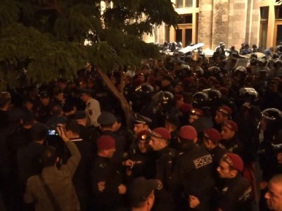 Police detain citizens outside government building