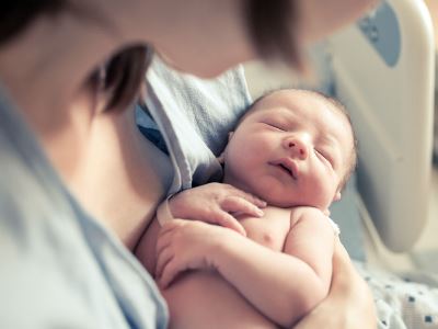 Why most people cradle babies in left arm?