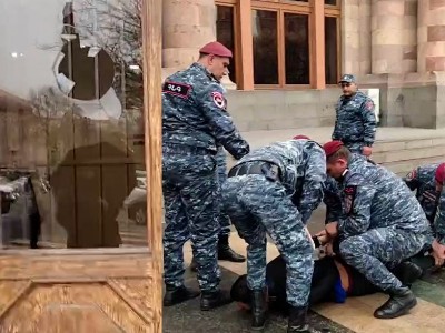 Young man throws stone at Armenia government building window