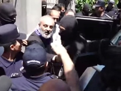 Armenia law enforcement officers leave Archbishop Bagrat Galstanyan’s residence with packages