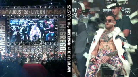 Floyd Mayweather throws dollars on Conor McGrego