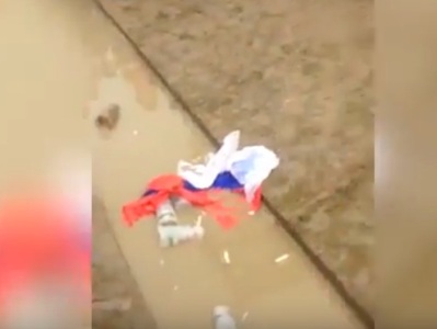 Drunken England football hooligan urinates on Russian flag