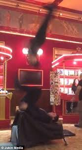Gymnast flips and lands perfectly on another gymnast's feet